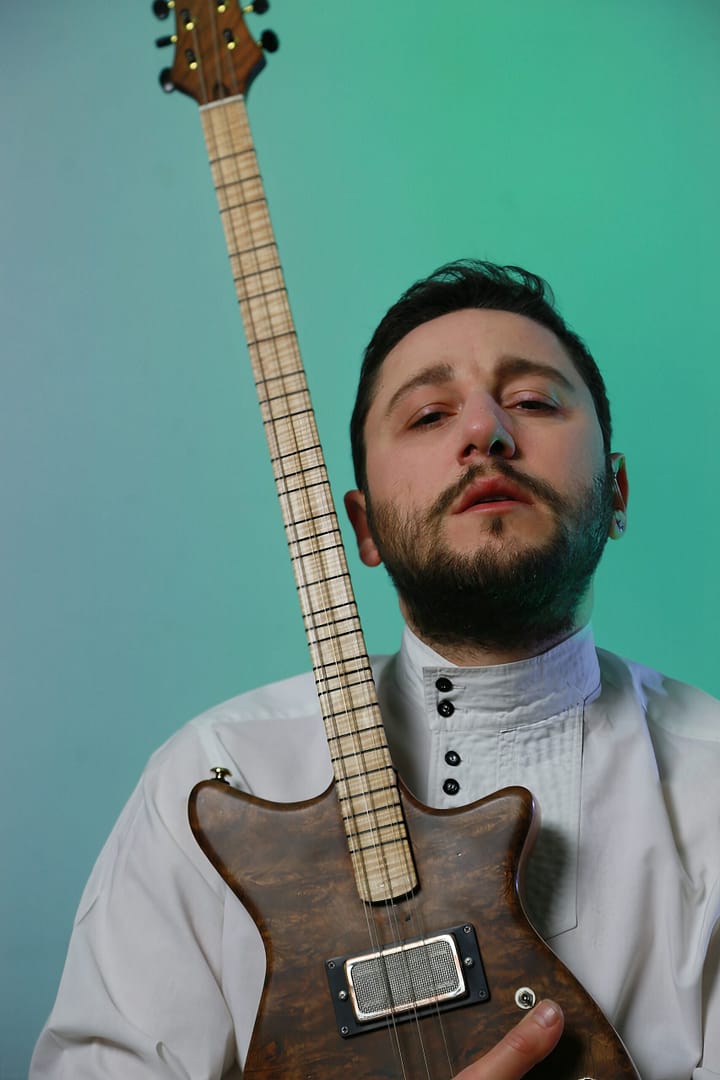 Mahir embracing his guitar 2
